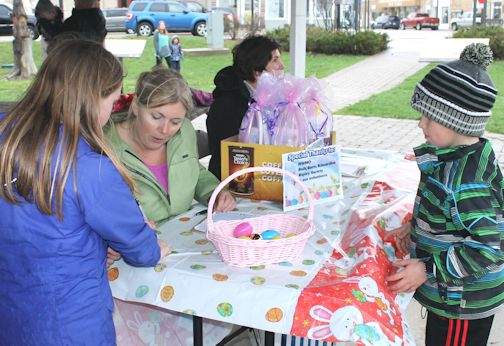Amy Fry (centre) registers youngsters to take part in the inaugural Ripley Easter Egg Hunt, Saturday morning in Lewis Park